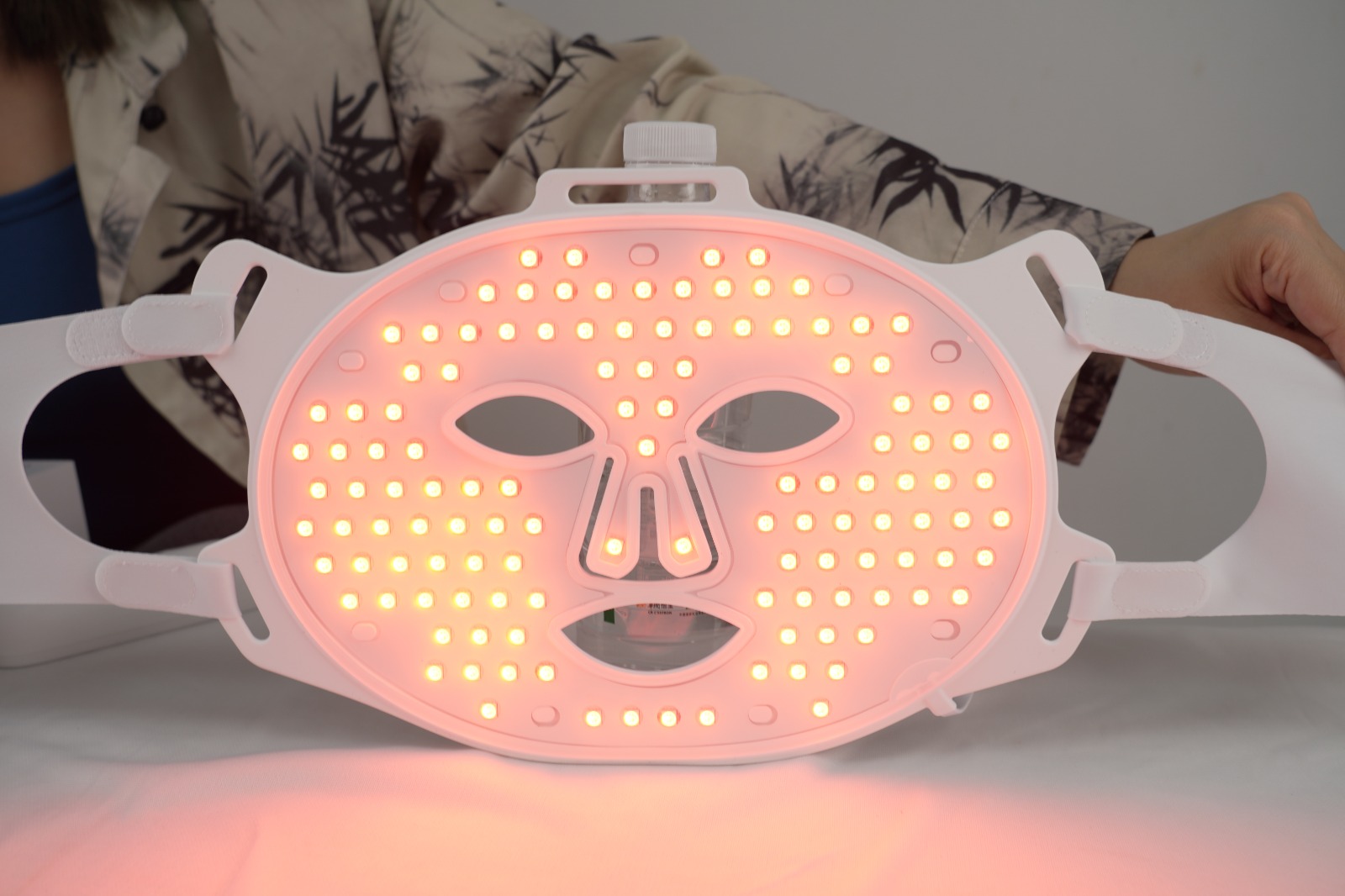 Starlight LED therapy mask glowing red — collagen & firmness mode